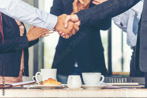 Fototapeta Naklejka Na Ścianę i Meble -  Team Business Partners shaking hands together to Greeting Start up small business in meeting room. Shakehand teamwork partners at modern office handshake together. Business mergers and acquisitions