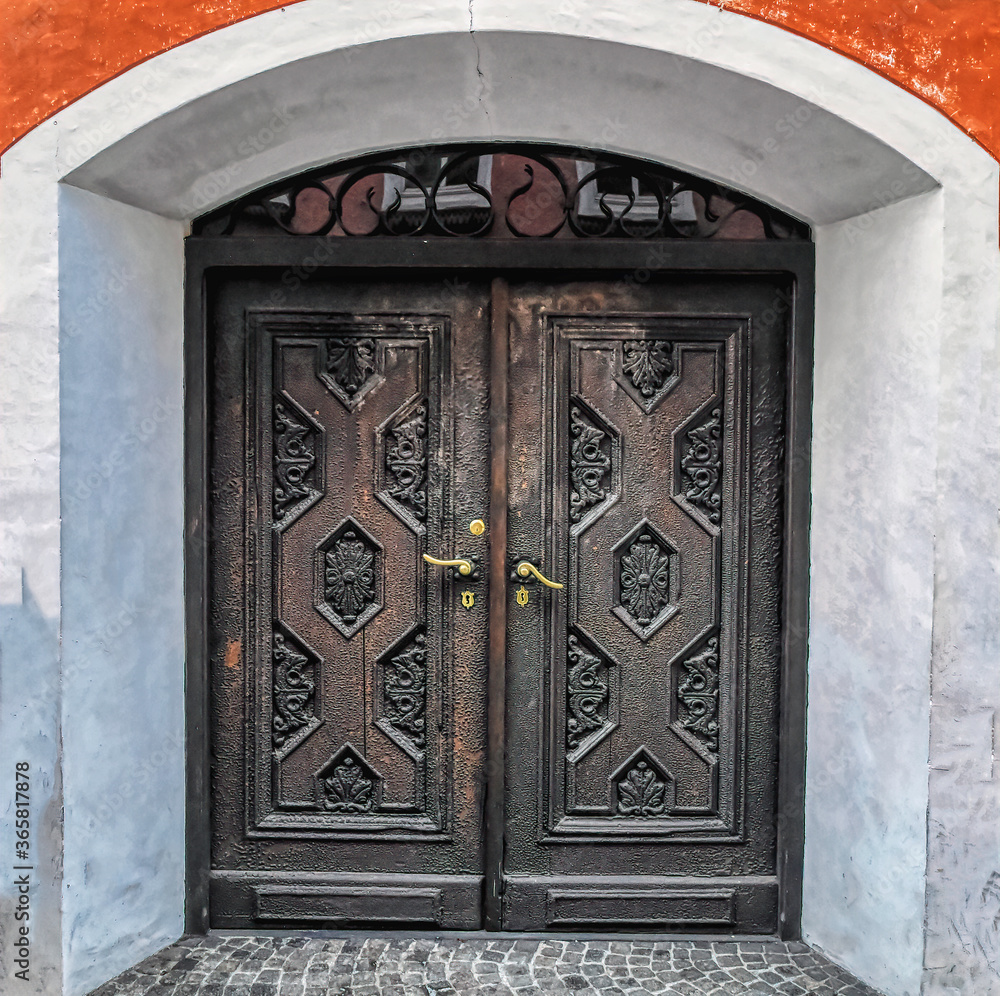 Old lock and handle on rustic wooden door. Natural texture of old wooden door with old lock and handle.