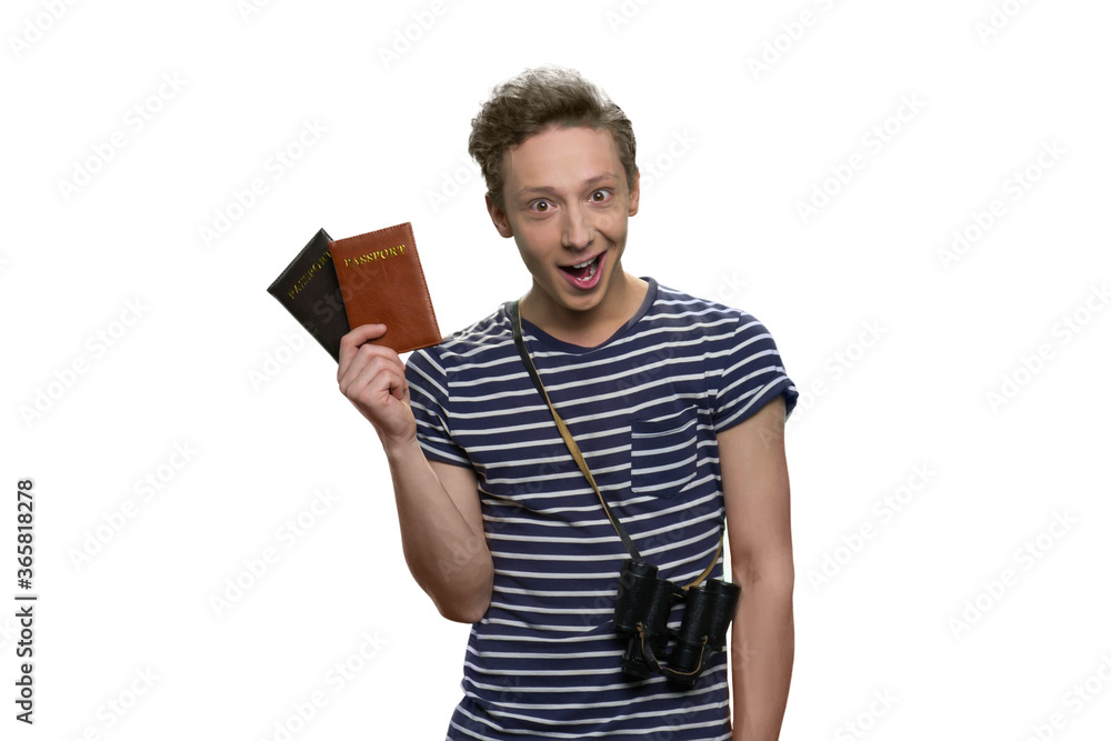 Portrait of happy teenage boy tourist with binoculars and passports. Travel and tourism concept. Isolated on white background. Portrait of happy teenage boy tourist with binoculars and passports. Travel and tourism concept. Isolated on white background.