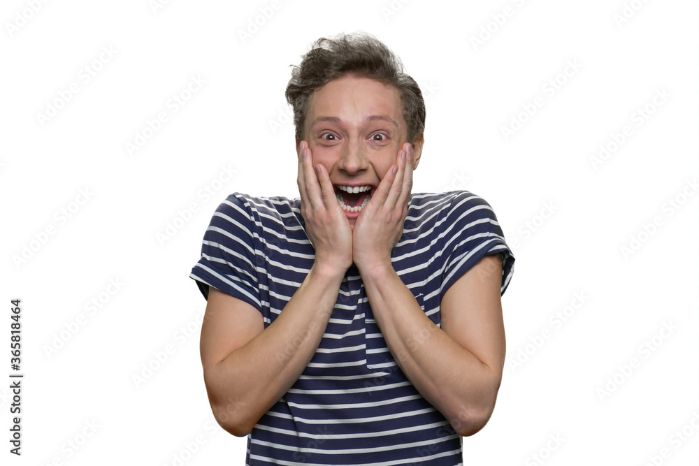 Happy shocked overwhelmed teen guy is touching his face. Surprised and astonished young guy isolated on white. Happy shocked overwhelmed teen guy is touching his face. Surprised and astonished young guy isolated on white.