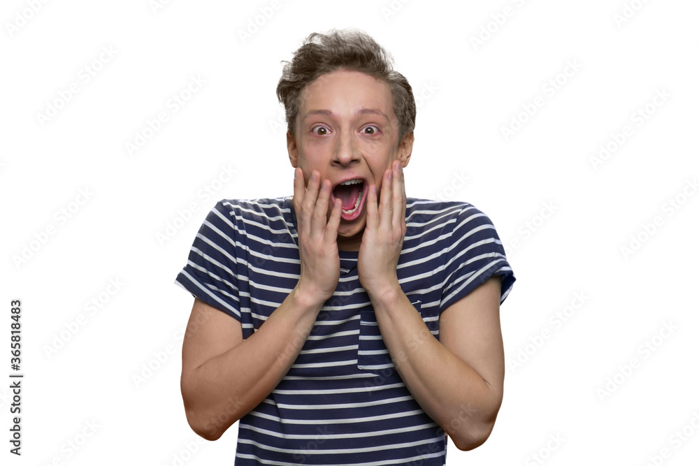 Shocked teenage boy with opened mouth is touching face. Isolated on white background. Shocked teenage boy with opened mouth is touching face. Isolated on white background.