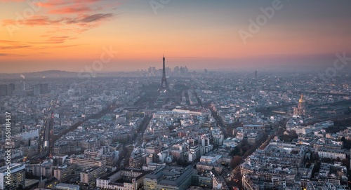 Aerial view of Paris cityscape - wide roads   many streets and buildings and the Eiffel Tower in the middle. Evening. France.