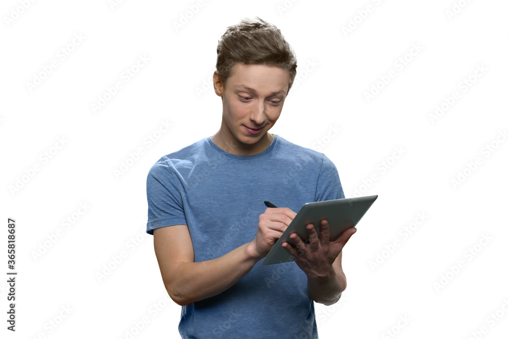 Portrait of teen boy handwriting on digital tablet pc. Isolated on white background. Portrait of teen boy handwriting on digital tablet pc. Isolated on white background.