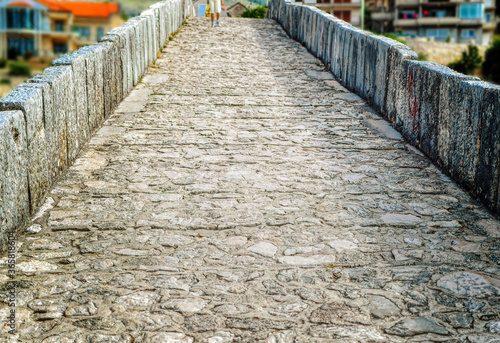 Old pedestrian path over stone made medieval bridge in city of Trebinje, Bosnia and Herzegovina.