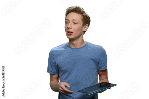 Portrait of tenage boy with a tablet pc. Isolated on white background. photo