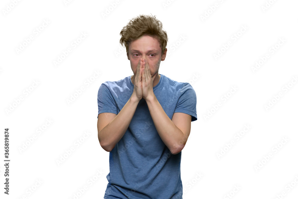 Portrait of extremely sad teenager isolated on white. Grief and sorrow concept. Portrait of extremely sad teenager isolated on white. Grief and sorrow concept.
