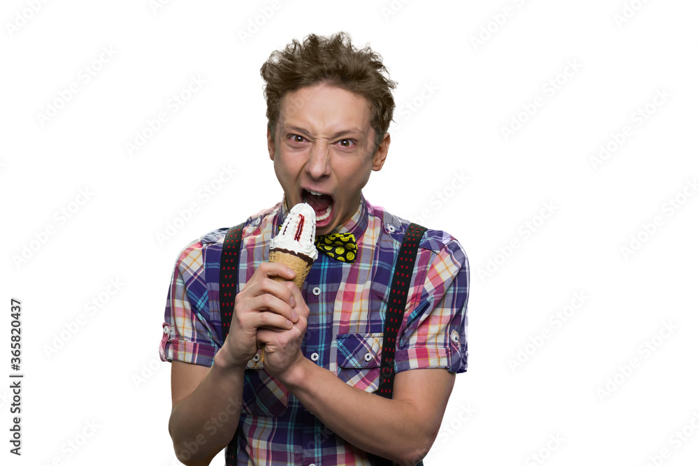Portrait of teenage boy biting cone ice-cream. Isolated on white background. Madness facial expression. Portrait of teenage boy biting cone ice-cream. Isolated on white background. Madness facial expression.