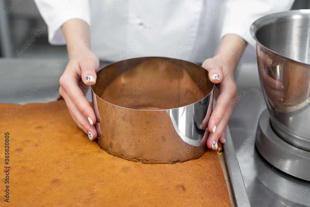 Pastry chef cuts out a cake cake from a biscuit Pastry chef cuts out a cake cake from a biscuit