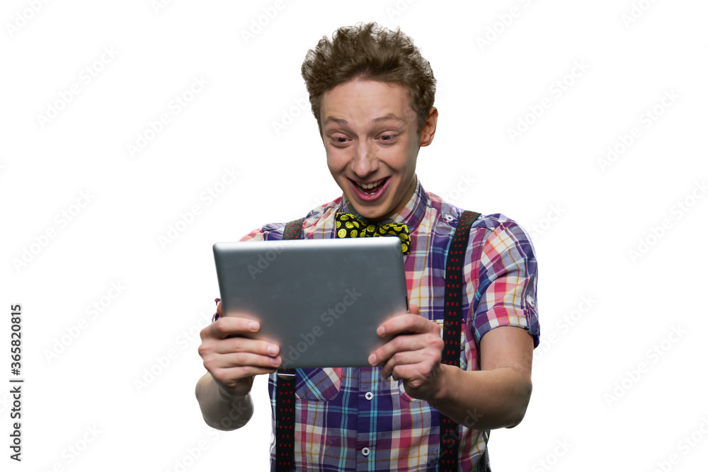 Happy cheerful teenage boy is looking at tablet pc. Isolated on white. Happy cheerful teenage boy is looking at tablet pc. Isolated on white.