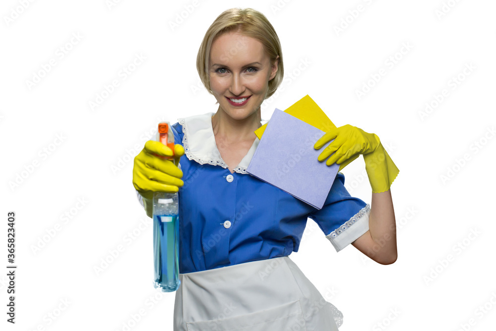 Smiling maid holding rag and pointing spray gun at camera on white background. House keeping concept Smiling maid holding rag and pointing spray gun at camera on white background. House keeping concept