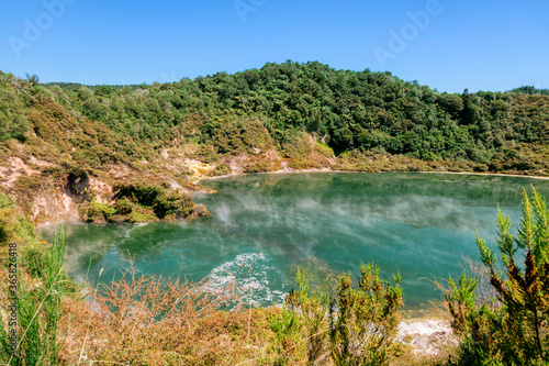 Green crater lake with rising steam in Waimangu Volcanic Valley photo