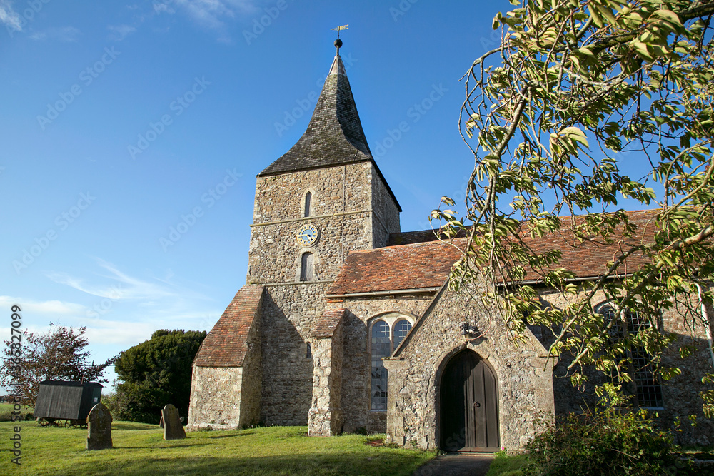 St Mary in the Marsh is an Anglican Church in New Romney - Kent. It has a traditional clock tower and spire which was added in the 15th century.