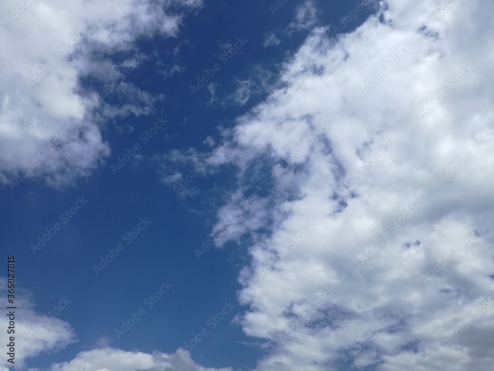 Blue sky background with clouds and sun reflection.The sun shines bright in the daytime in summer. Stock image illustration. Blue sky background with clouds and sun reflection.The sun shines bright in the daytime in summer. Stock image illustration.