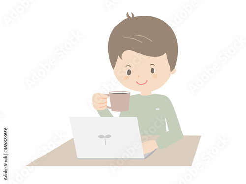 Young man drinking coffee while looking at a laptop.