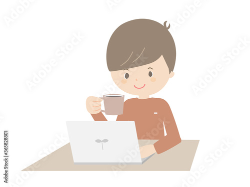 Young man drinking coffee while looking at a laptop.