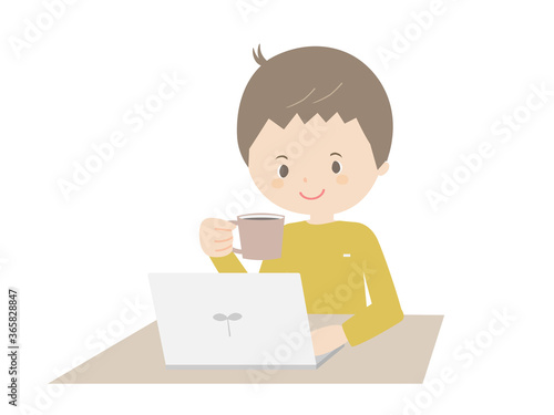 Young man drinking coffee while looking at a laptop.