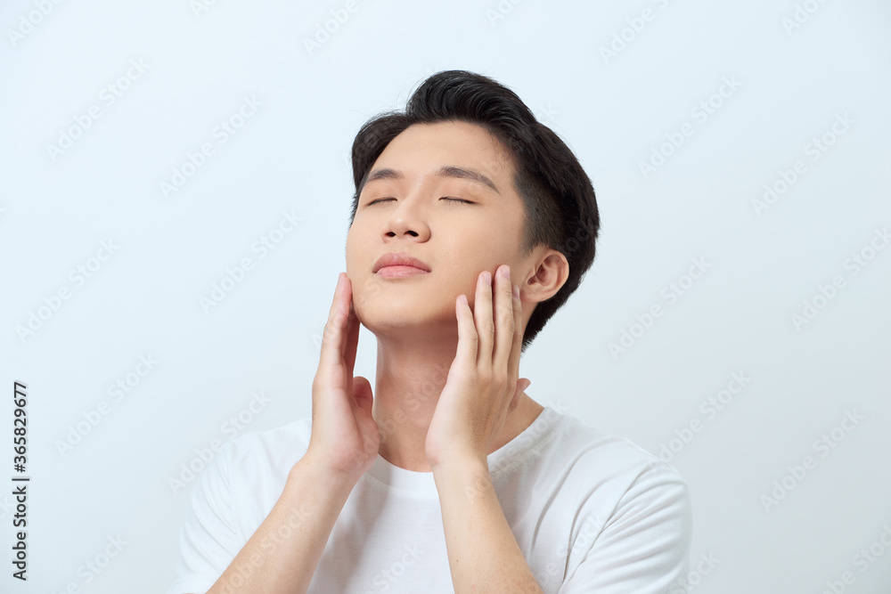 Handsome man touching his face close up portrait studio on white background Handsome man touching his face close up portrait studio on white background