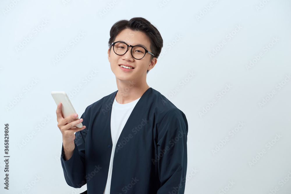 Young handsome asian man using mobile phone Young handsome asian man using mobile phone