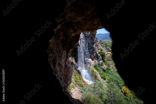 Waterfall through cave with text space around it