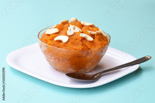 Indian traditional sweet,Plain SemolinaSuji Halwa also known as Sweet Rava Sheera OR Shira - Indian festival sweet garnished with dry fruitsServed in a plate or Bowl,Indian dessert photo