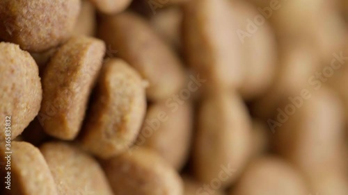UHD macro of the healthy dry food for dog or cat on rotating stand. Dry Pet Food Rotating. Nutrition for Cats and Dogs