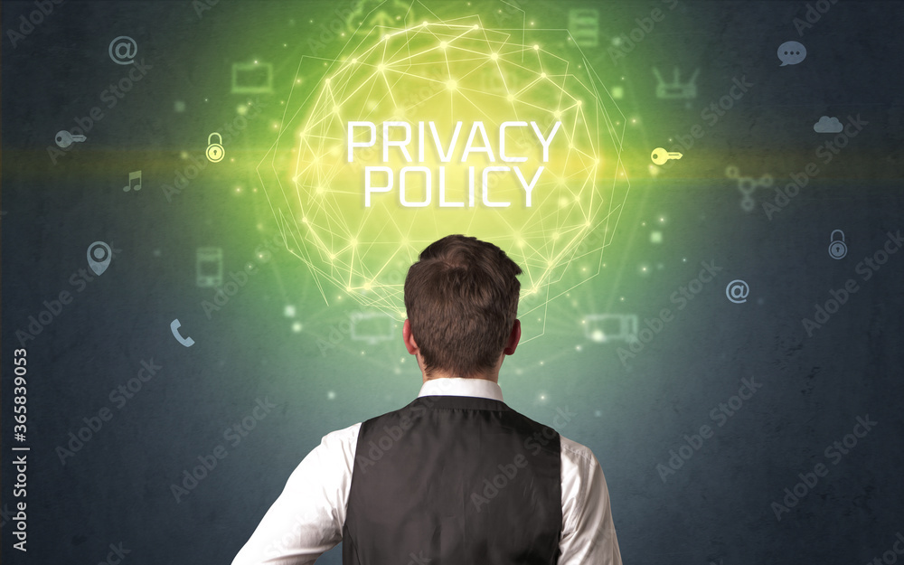 Rear view of a businessman with PRIVACY POLICY inscription, online security concept Rear view of a businessman with PRIVACY POLICY inscription, online security concept