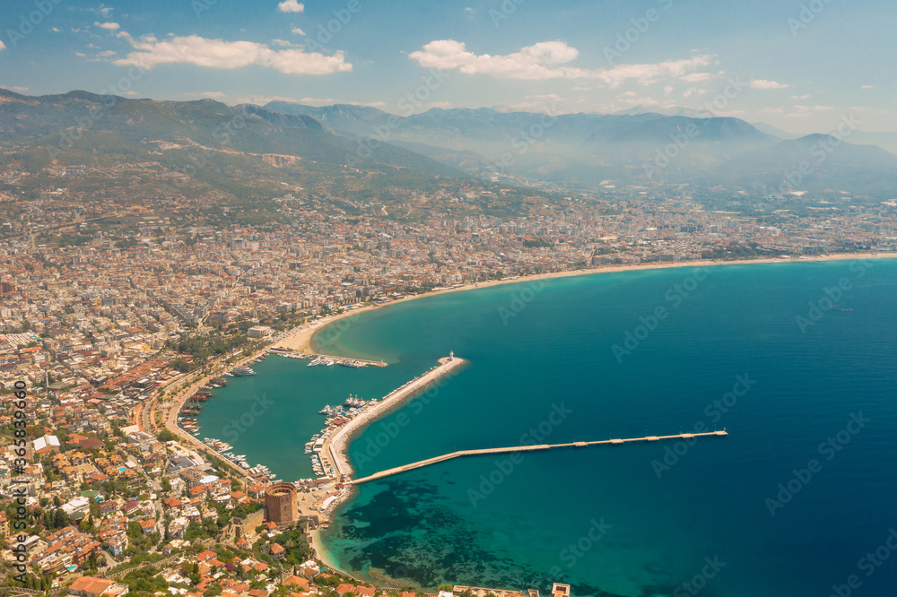 Aerial view of the Antalya city. Mediterranean sea, and the coast of Antalya. Mountains and sky in the background. Turkey