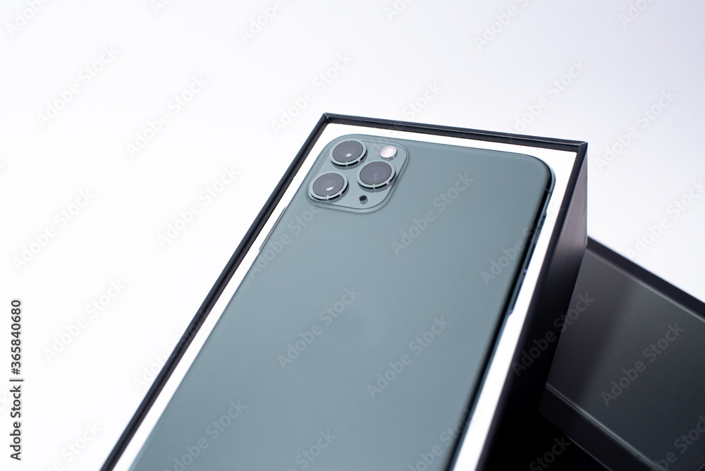 Green smartphone with three cameras on a white background Green smartphone with three cameras on a white background