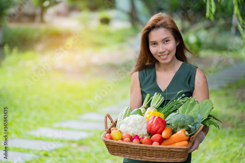 woman carrying vegetables basket with blur background 