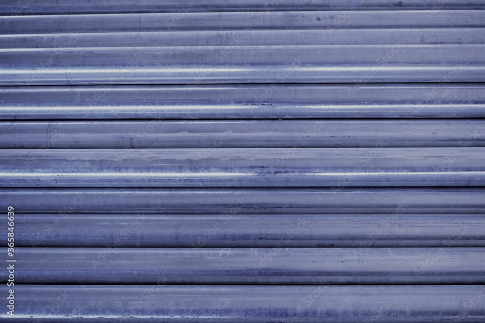 Steel GI Pipes in the workshop and galvanized steel tubes in the background. gi pipes. Steel GI Pipes in the workshop and galvanized steel tubes in the background. gi pipes.