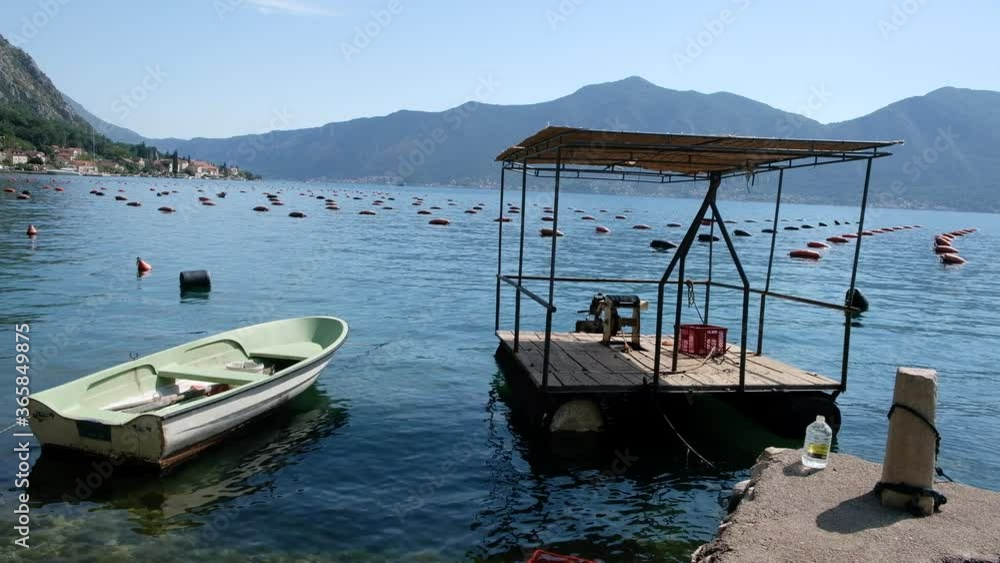fishing boat on an oyster farm in the Bay of Kotor, Montenegro fishing boat on an oyster farm in the Bay of Kotor, Montenegro