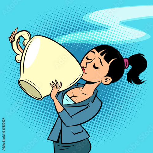 a small woman drinks a huge Cup of tea or coffee