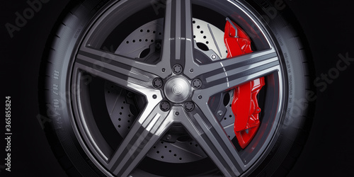 Car wheel with red breaks on black background.