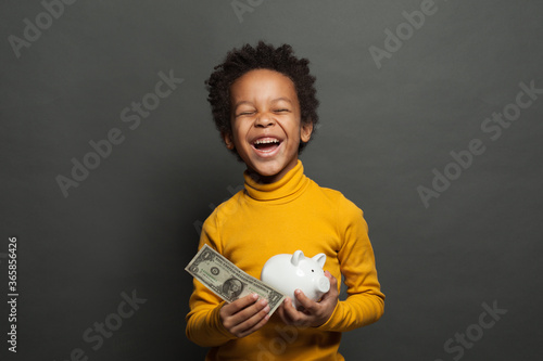 Happy black child boy with us dollar and money box