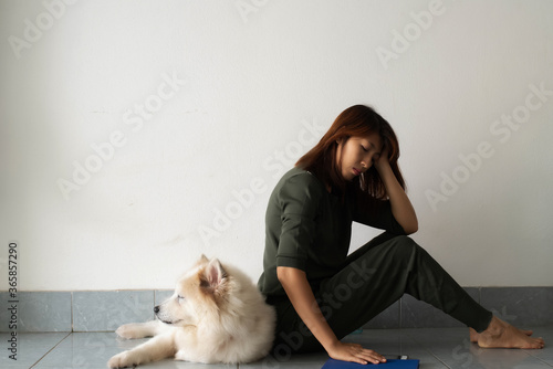 Stressed woman sitting beside her dog