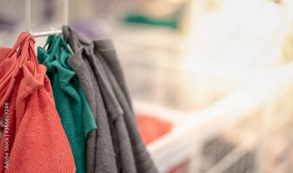 Many colour towels hanging on the stand in supermarket. For the customer choose for use inside the house Many colour towels hanging on the stand in supermarket. For the customer choose for use inside the house