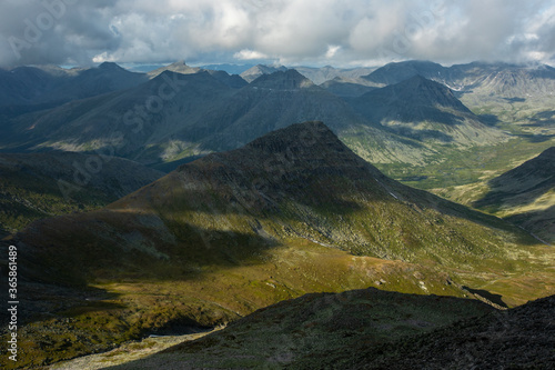 Amazing mountain landscape with colorful sky. Travel and hiking concept. Mountain landscape Subpolar Ural view from Mount Manaraga. Queen of the Ural Mountains.