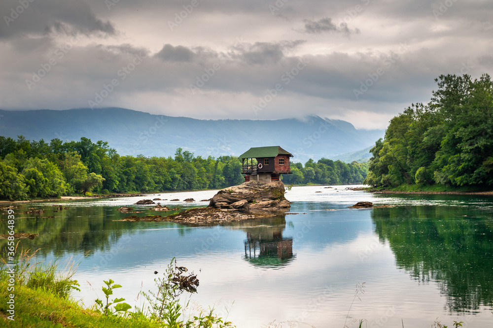 Obraz premium Small house on a stone on Drina river, near the Bajina Basta in Serbia