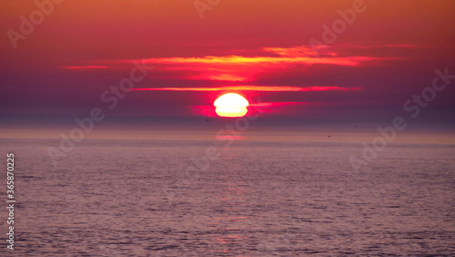 Fototapeta Naklejka Na Ścianę i Meble -  Orange, pink, purple, red sunset over the sea