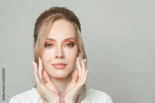 Beautiful female face close up portrait. Perfect woman with clear healthy skin and blonde hair