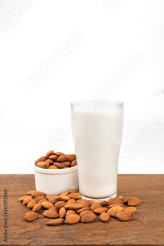 Close Up glass of Almond milk with Almond seeds. on white background