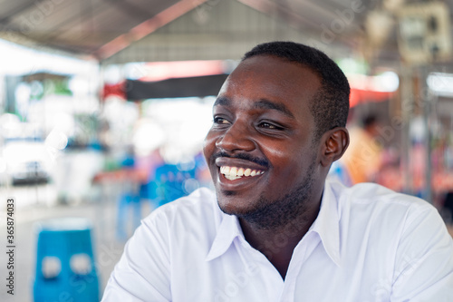 African man smiling with wear white shirt