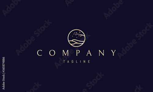 Vector golden logo on which an abstract image of a hilly landscape with a tree in a circle.