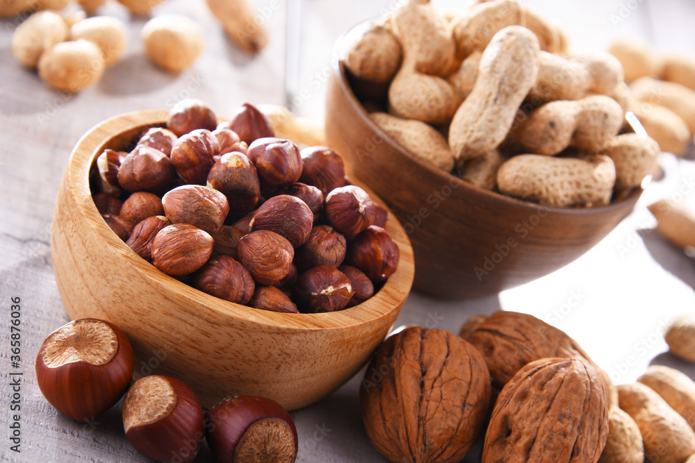 Composition with two bowls of hazelnuts and peanuts Composition with two bowls of hazelnuts and peanuts
