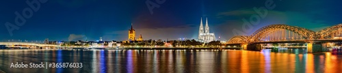 Panorama of Cologne by night, with Hohenzollern Bridge over the Rhine River and Cologne Cathedral