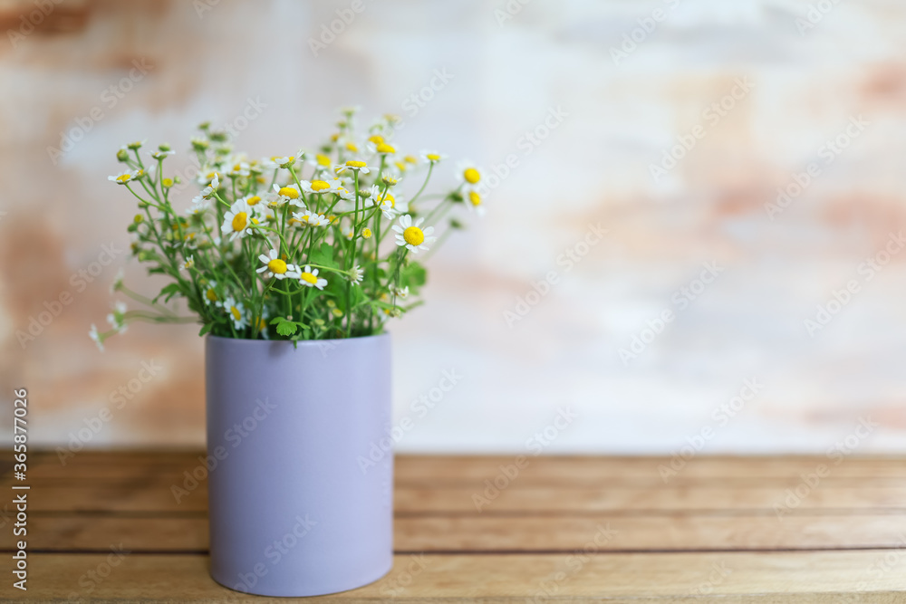 Round vase of white and yellow Chamomile flower on wooden table with copy space. Round vase of white and yellow Chamomile flower on wooden table with copy space.