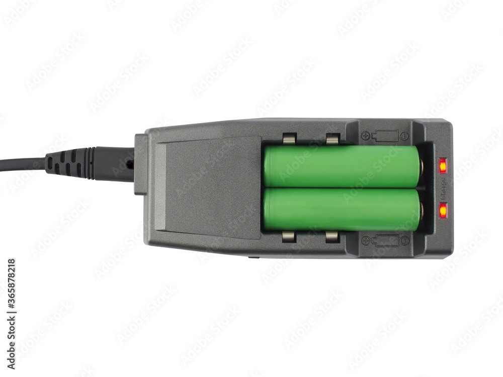 two green rechargeable batteries are charging in dark gray battery charger with red indicator light isolated on white background, flat lay close up top view two green rechargeable batteries are charging in dark gray battery charger with red indicator light isolated on white background, flat lay close up top view