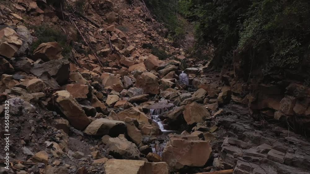 Carpathian mountains. The consequences of a mountain collapse in the forest. A spring flowing down from the mountains Carpathian mountains. The consequences of a mountain collapse in the forest. A spring flowing down from the mountains