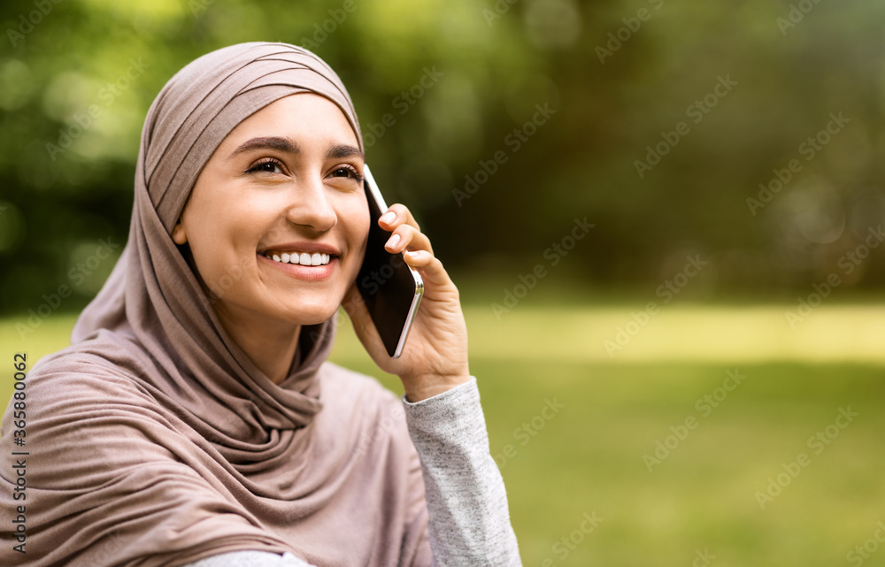 Closeup portrait of happy muslim woman talking on phone Closeup portrait of happy muslim woman talking on phone