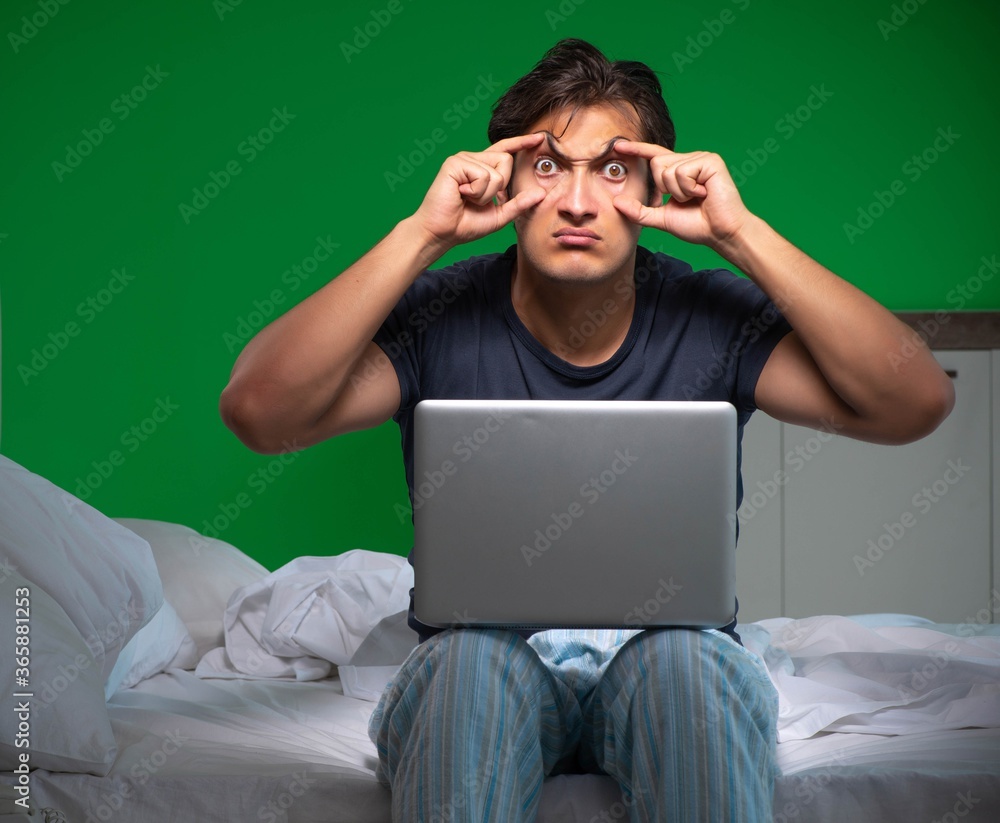 Young handsome man suffering from insomnia at home Young handsome man suffering from insomnia at home